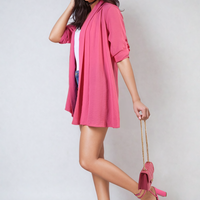 Bright pink open-front cardigan with rolled sleeves and flowing drape