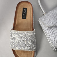 Silver stone-embellished slide sandals with cushioned footbed and braided edge sole