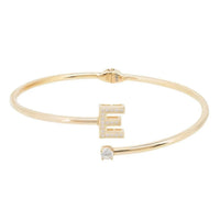 Gold-tone initial E bangle bracelet with central E charm and clear stones