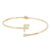 Gold initial F bangle with crystal baguette and round stone cross detail