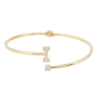 Gold tone initial bangle with square and round clear stones forming letter I