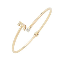 Gold bangle bracelet with J initial and small clear stone