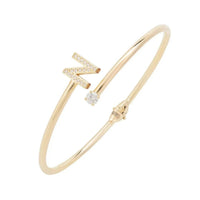 Gold tone initial N bangle with rhinestone letter and small crystal accent