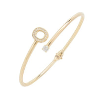 Gold-tone bangle with O initial charm and clear stone accents
