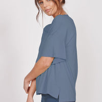 Oversized blue v-neck t-shirt with short sleeves, side drape detail