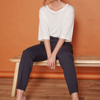 High-waist black tapered trousers with ankle-length fit