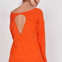 Back view: orange training top with keyhole cutout and open back panel