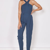 Navy tailored sleeveless jumpsuit with high cross halter neck and front pockets