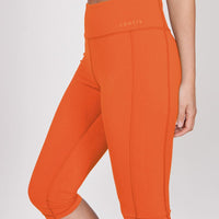 Orange 3/4 sports leggings, hidden zip pocket detail and knee-length hem