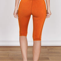 Orange 3/4 sports leggings with hidden zip pocket, front seam and cuffed hem