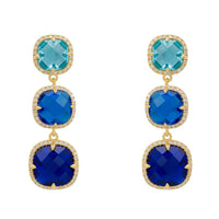 Gold-tone drop earrings with three blue faceted stones and halo details