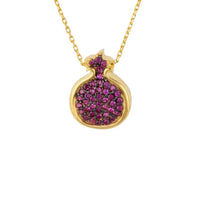 Gold pendant necklace with ruby-pink pomegranate-shaped charm and crystal-set rim
