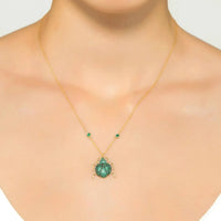 Gold-tone pendant necklace with small round green beads and green scarab charm