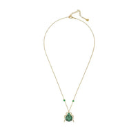 Gold-tone necklace with green scarab pendant and small bead accents