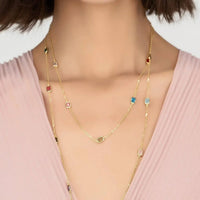 Gold layered rainbow bead necklace with small colored charms and clasp