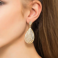 Gold teardrop earring with pavΓ© crystal swirl design