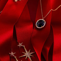 Gold chain oval blue gemstone pendant with halo surround