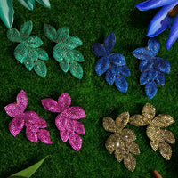Assorted rhinestone flower earrings in green, blue, pink, and gold