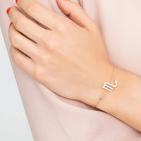 Rose-gold tone Scorpio bracelet with small scorpion zodiac charm on wrist