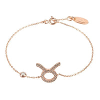 Gold-tone Taurus zodiac charm bracelet with chain, round bead, and star sign symbol