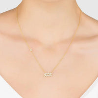 Gold Aquarius star sign pendant necklace on neckline with zigzag crystal charm