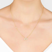 Gold Cancer pendant necklace worn at collarbone with thin linked chain