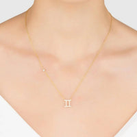Gold Gemini zodiac pendant necklace worn on neck with thin chain