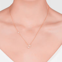 Rose gold zodiac pendant necklace with Sagittarius symbol charm, close-up