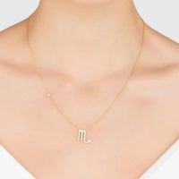 Rose gold Scorpio M zodiac pendant necklace worn at the neckline