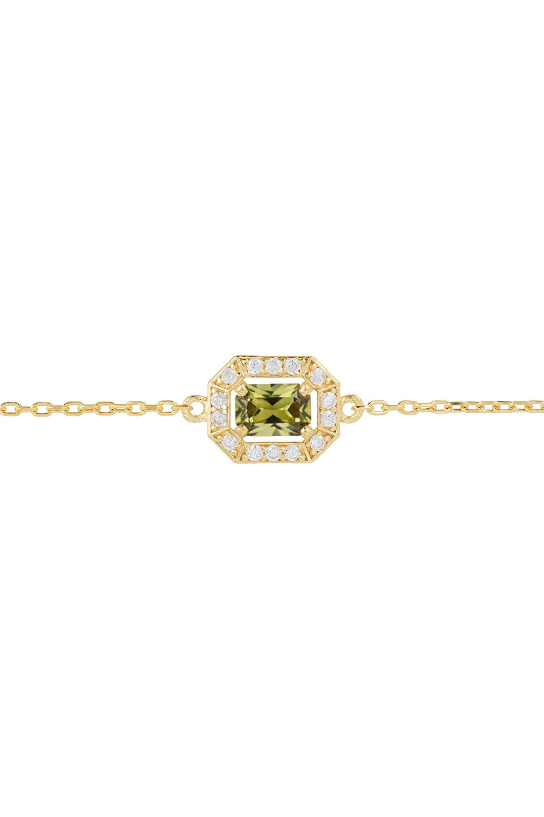 Gold bracelet close-up with green octagon gemstone centerpiece and crystal halo