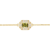 Gold bracelet close-up with green octagon gemstone centerpiece and crystal halo