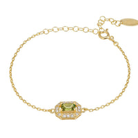 Gold gemstone bracelet with green octagon center stone and crystal halo links