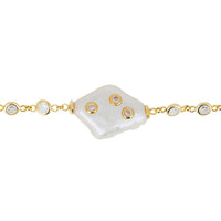Gold bracelet with heart-shaped charm, pearl-like links, and clasp detail