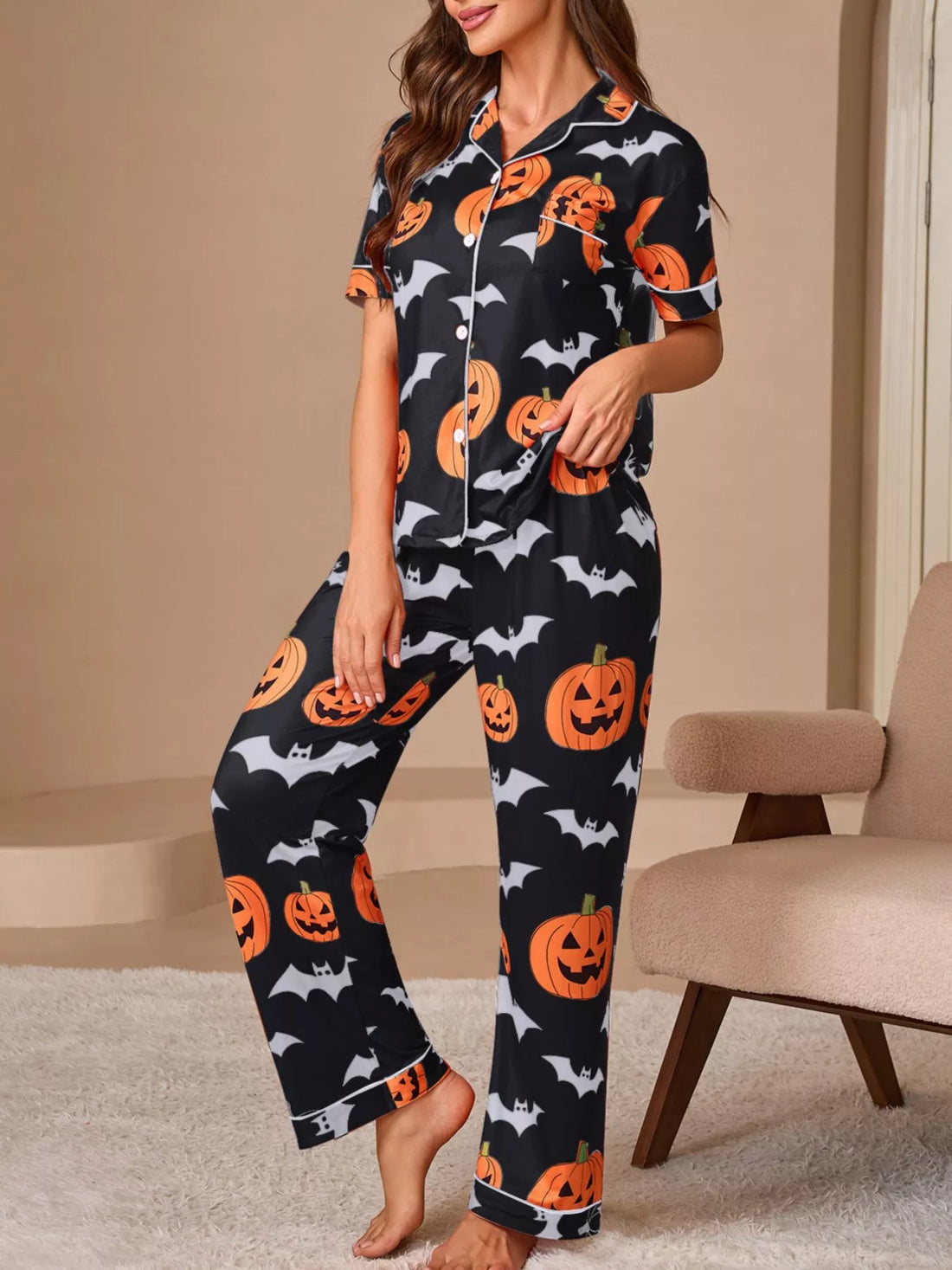 Black pajama lounge set with orange pumpkins and bats, short-sleeve button top and pants