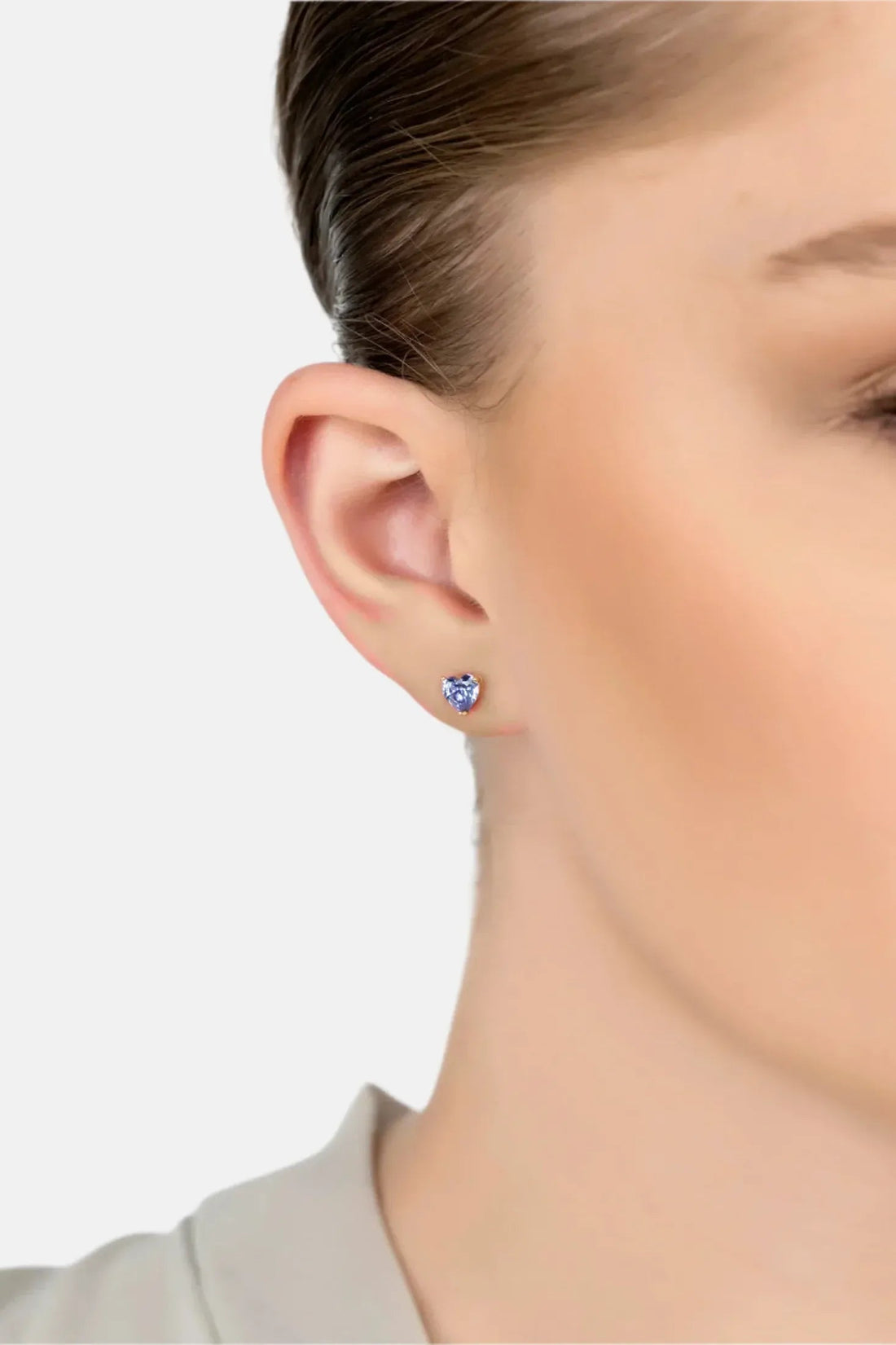 Gold heart stud earrings with blue asscher-cut gemstone