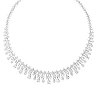 Silver crystal statement necklace laid flat with teardrop fringe and center drop
