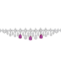 Tennis bracelet with clear stones and ruby-colored teardrop center drops.