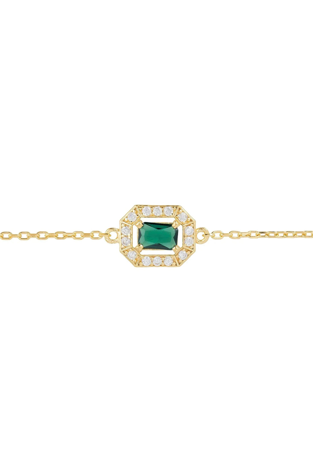 Close-up of gold chain bracelet with emerald green gemstone centerpiece