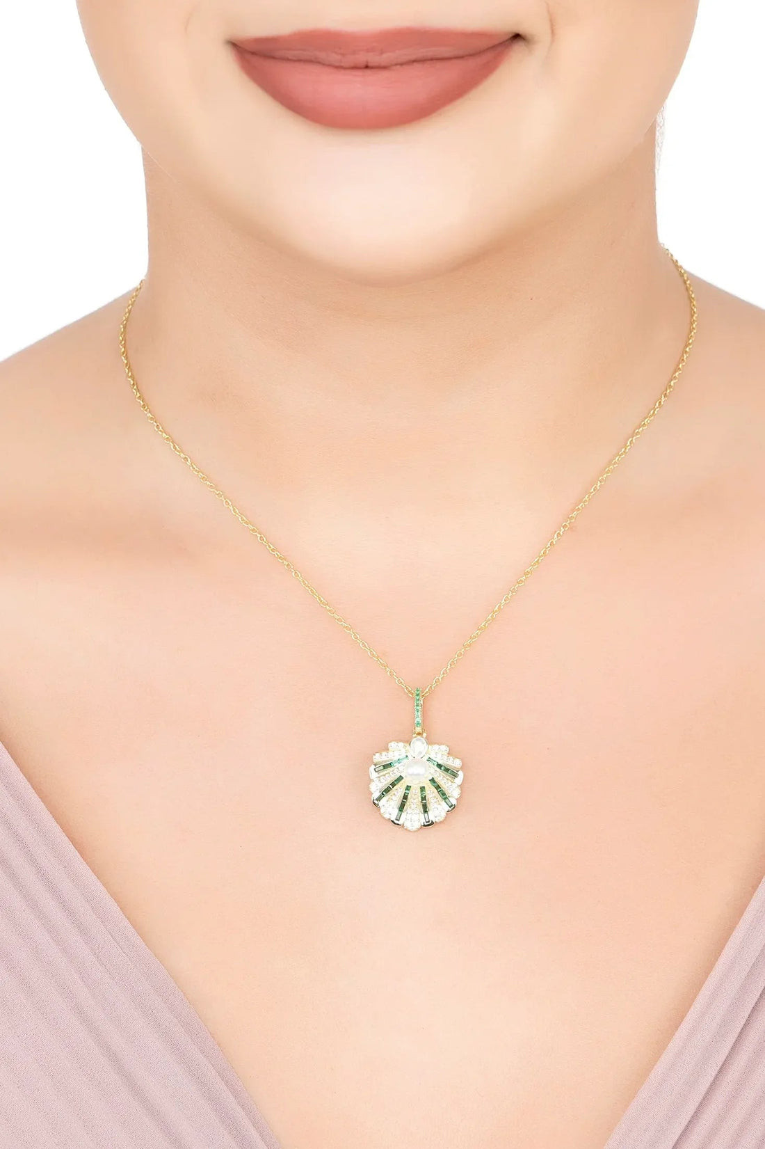 Art deco shell pendant necklace with pearl center and emerald details on gold chain