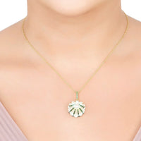 Art deco shell pendant necklace with pearl center and emerald details on gold chain