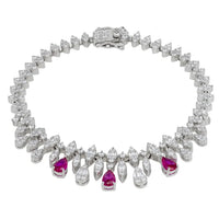 Silver tennis bracelet with clear stones and ruby-colored teardrop accents.