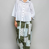 Off-white button-front shirt with short sleeves and tonal dot pattern