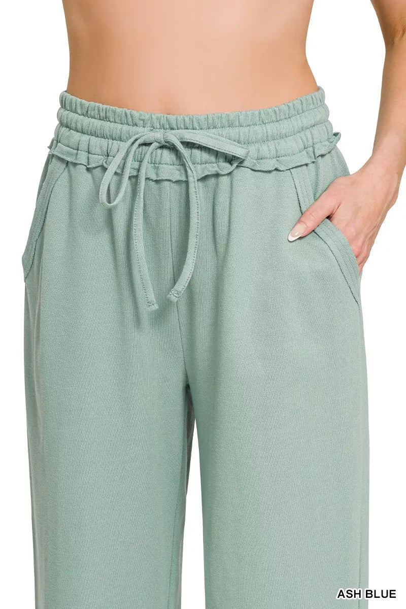 Ash blue wide-leg sweatpants with elastic waist, drawstring ties, and slant pockets