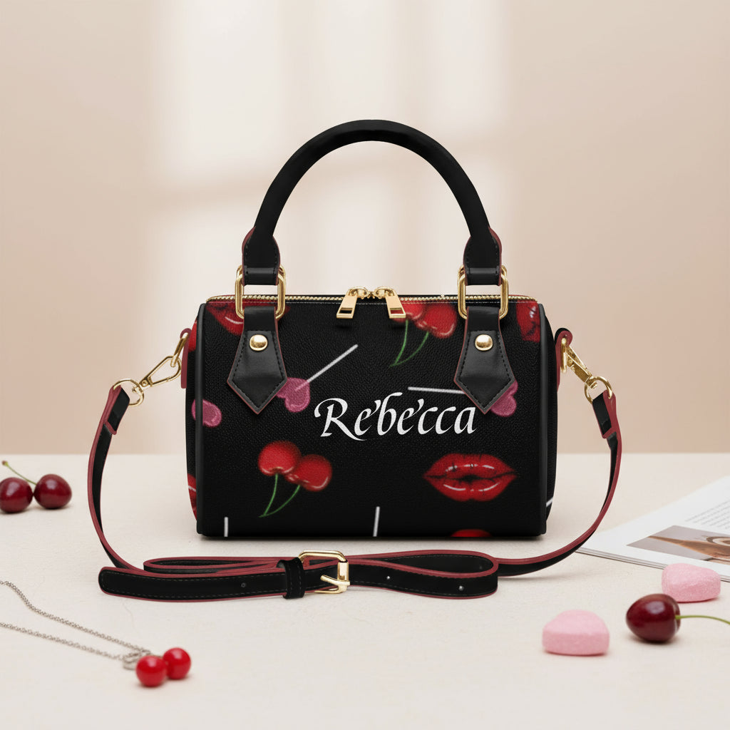 Black handbag with cherry and lip design, featuring the name &