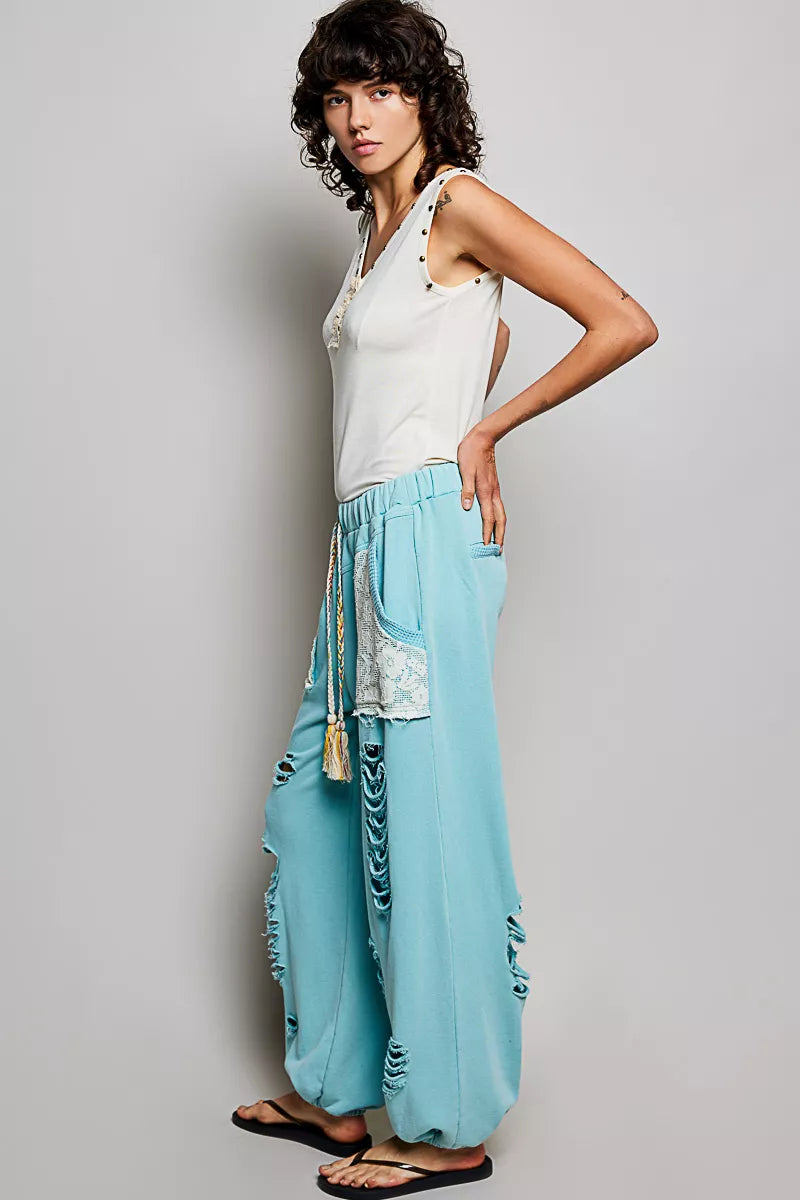 Cream sleeveless tank with studded trim, button placket, and ruffle detail