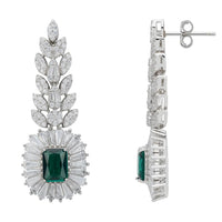 Emerald gemstone drop earrings in silver-tone, shown from the side with backs