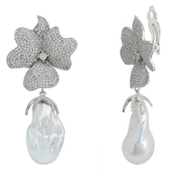 Flower drop clip-on earrings with silver glitter flowers and white pearl dangles, side view