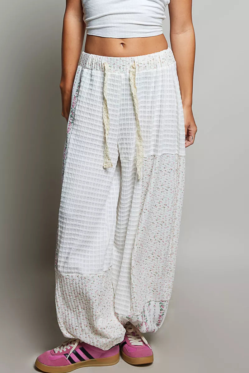 Ivory patchwork knit wide-leg pants with drawstring waist and multicolor speckle panel