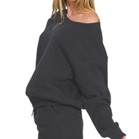 Black off-shoulder fleece sweatshirt with long sleeves and matching drawstring shorts