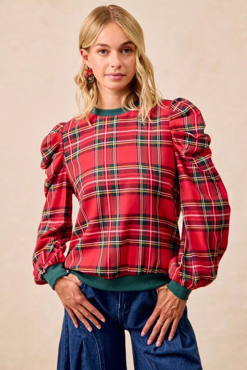 Red plaid puff-sleeve top with exaggerated shoulders and green ribbed cuffs
